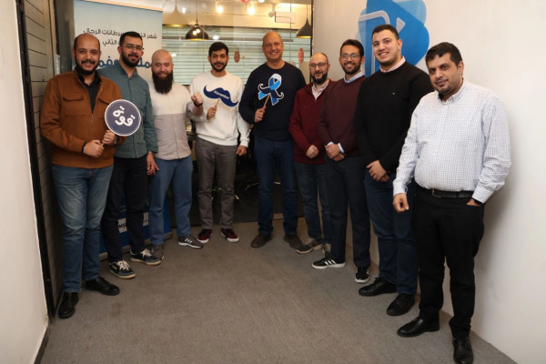 Whitney leaning against a railing on a downtown street